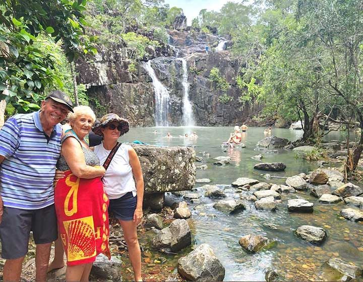 Guests posing in front of Cedar Creek Falls and its swimming hole in Conway National Park