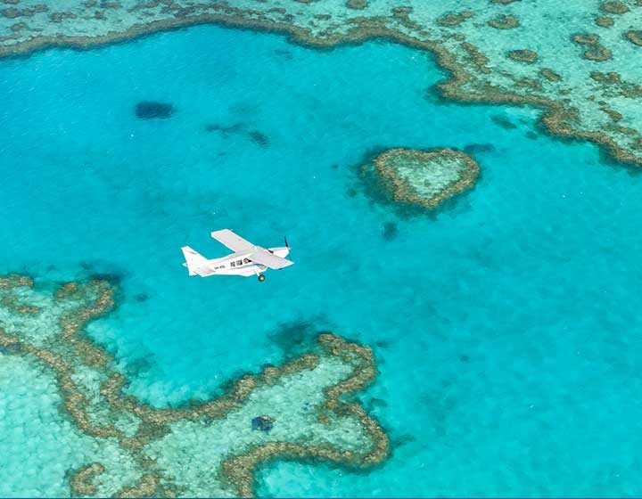 Ocean Rafting scenic flight plane over Heart Reef and the turquoise lagoons of the Great Barrier Reef