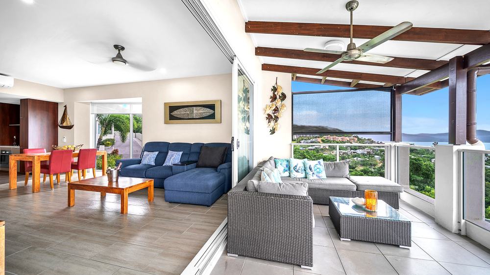 1 bedroom apartment lounge opening onto the terrace at Whitsunday Reflections, Airlie Beach