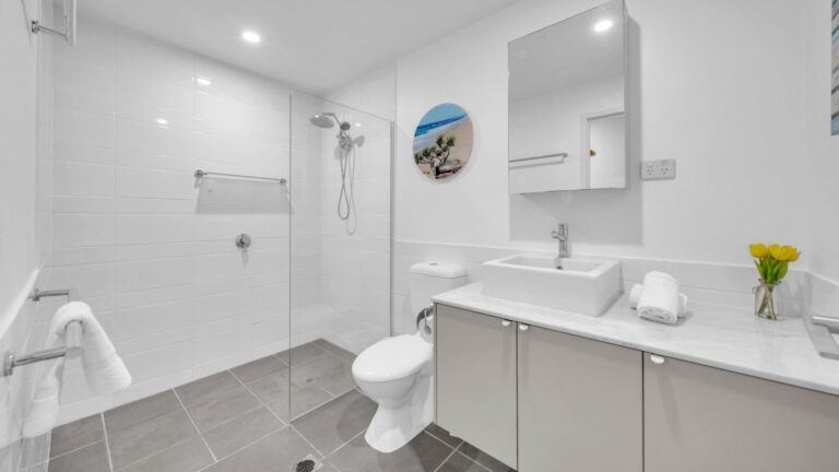 Second bathroom with walk-in shower, stone-topped vanity and mirrored cabinet, 2 bedroom apartment at Whitsunday Reflections, Airlie Beach