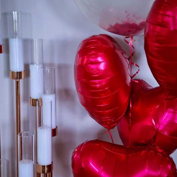 Red foil heart balloons with a clear confetti balloon, balloon decorations delivered to Whitsunday Reflections, Airlie Beach