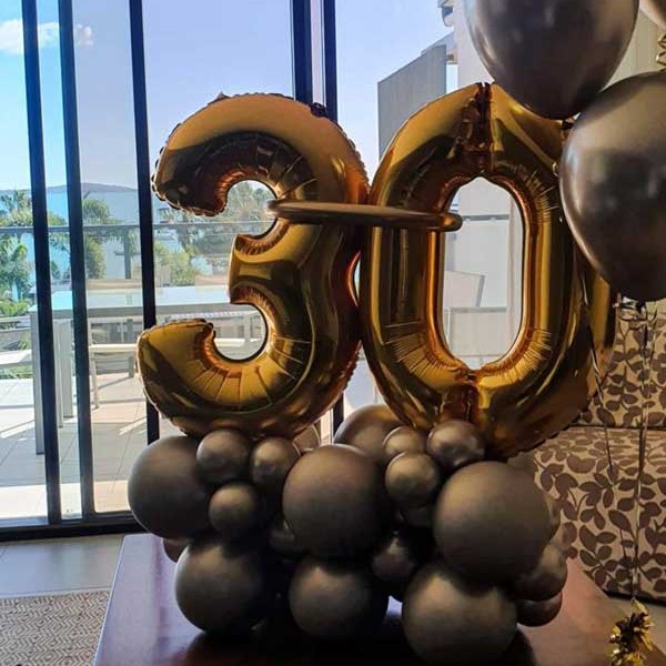 Gold foil number 30 balloons on a base of chrome latex balloons in a Whitsunday Reflections apartment, Airlie Beach