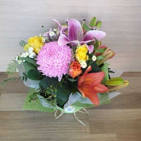 Bright arrangement of pink lilies, chrysanthemum, yellow roses and orange tulips, flowers delivered to Whitsunday Reflections, Airlie Beach