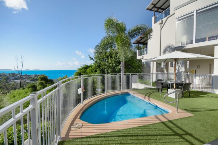 Heated spa on a garden terrace with an outdoor dining setting under an umbrella, looking over Airlie Beach to the Coral Sea and Whitsunday Islands, Whitsunday Reflections, Airlie Beach
